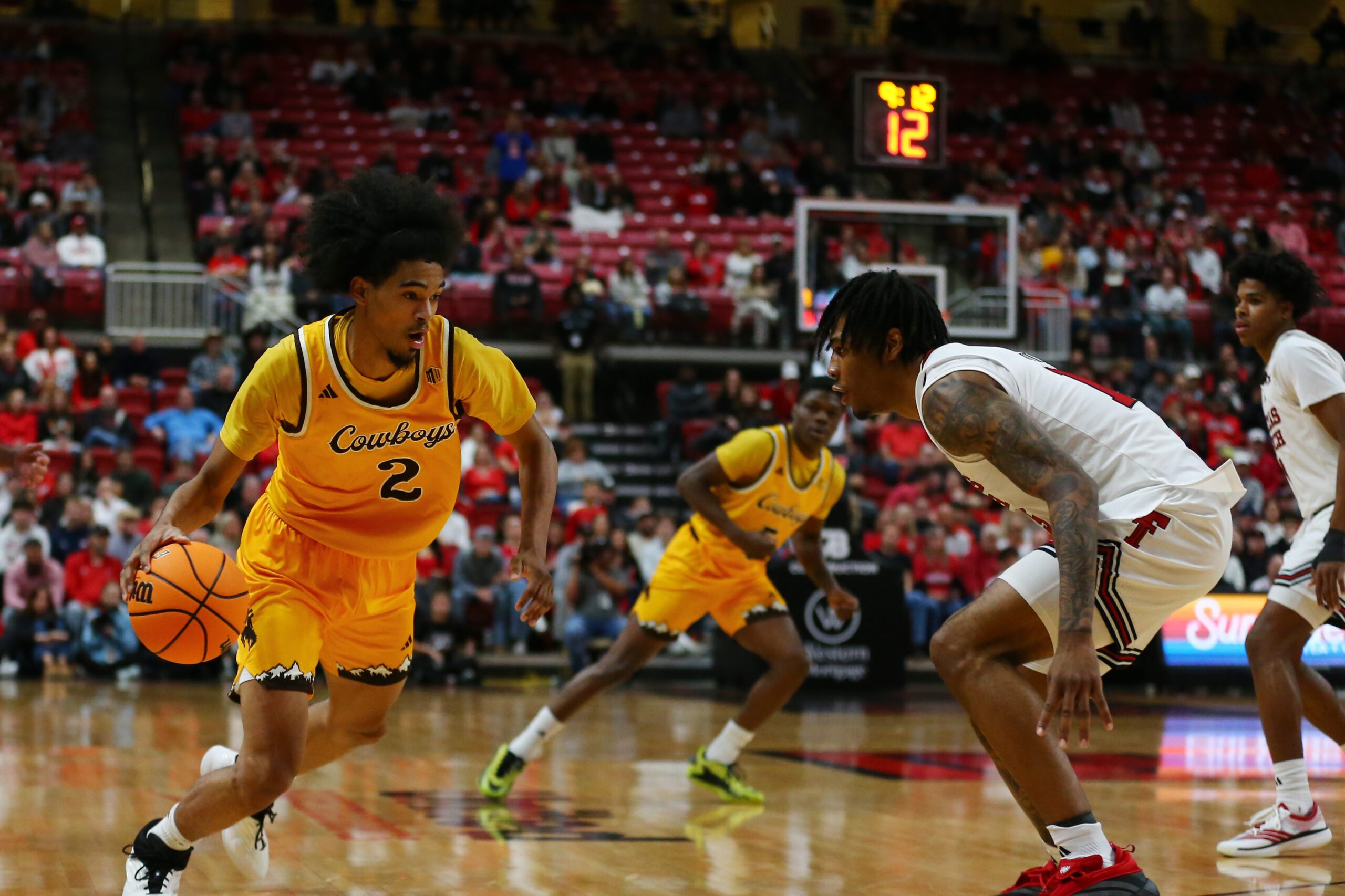 Nov 30, 2025; Lubbock, Texas, USA;  Wyoming Cowboys guard Nasir Meyer (2) drives to the basket against Texas Tech Red Raiders forward JT Toppin (15) in the second half at United Supermarkets Arena. Mandatory Credit: Michael C. Johnson-Imagn Images