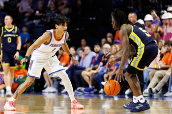 Nov 21, 2025; Gainesville, Florida, USA; Florida Gators guard Xaivian Lee (1) defends Merrimack Warriors guard Kevair Kennedy (5) during the second half at Exactech Arena at the Stephen C. O'Connell Center. Mandatory Credit: Matt Pendleton-Imagn Images