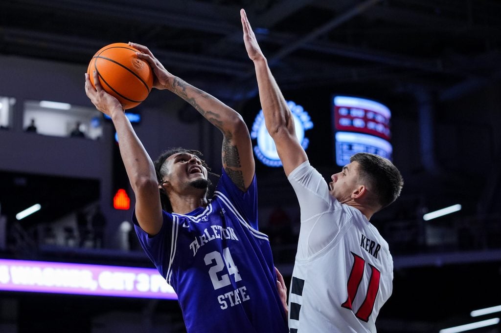 Dec 1, 2025; Cincinnati, Ohio, USA; Tarleton State Texans forward Ocypher Owens (24) drives to the basket against Cincinnati Bearcats guard Kerr Kriisa (11) in the second half at Fifth Third Arena. Mandatory Credit: Aaron Doster-Imagn Images