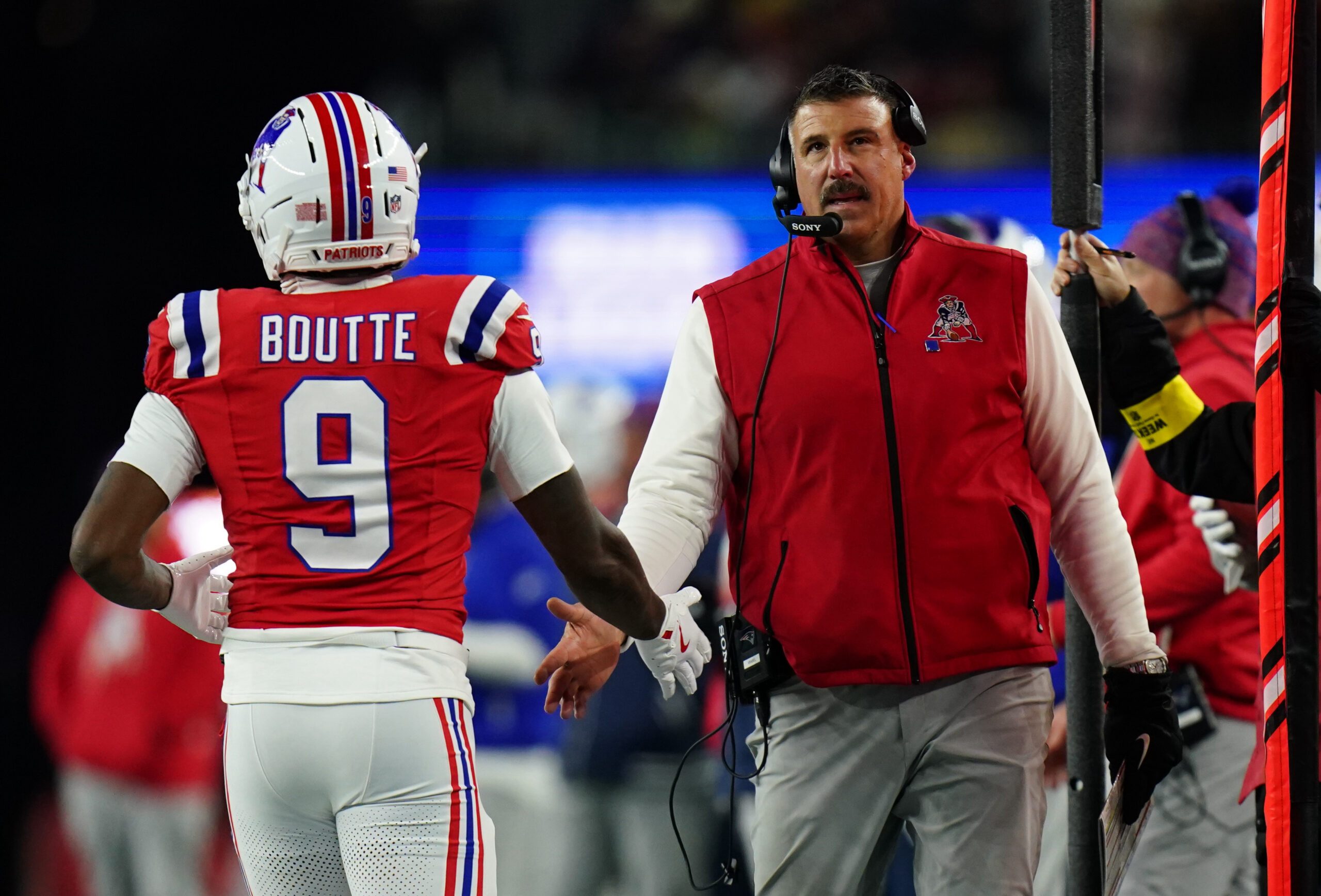 Dec 1, 2025; Foxborough, Massachusetts, USA; New England Patriots wide receiver Kayshon Boutte (9) high-fives New England Patriots head coach Mike Vrabel on the sideline during the third quarter at Gillette Stadium. Mandatory Credit: David Butler II-Imagn Images