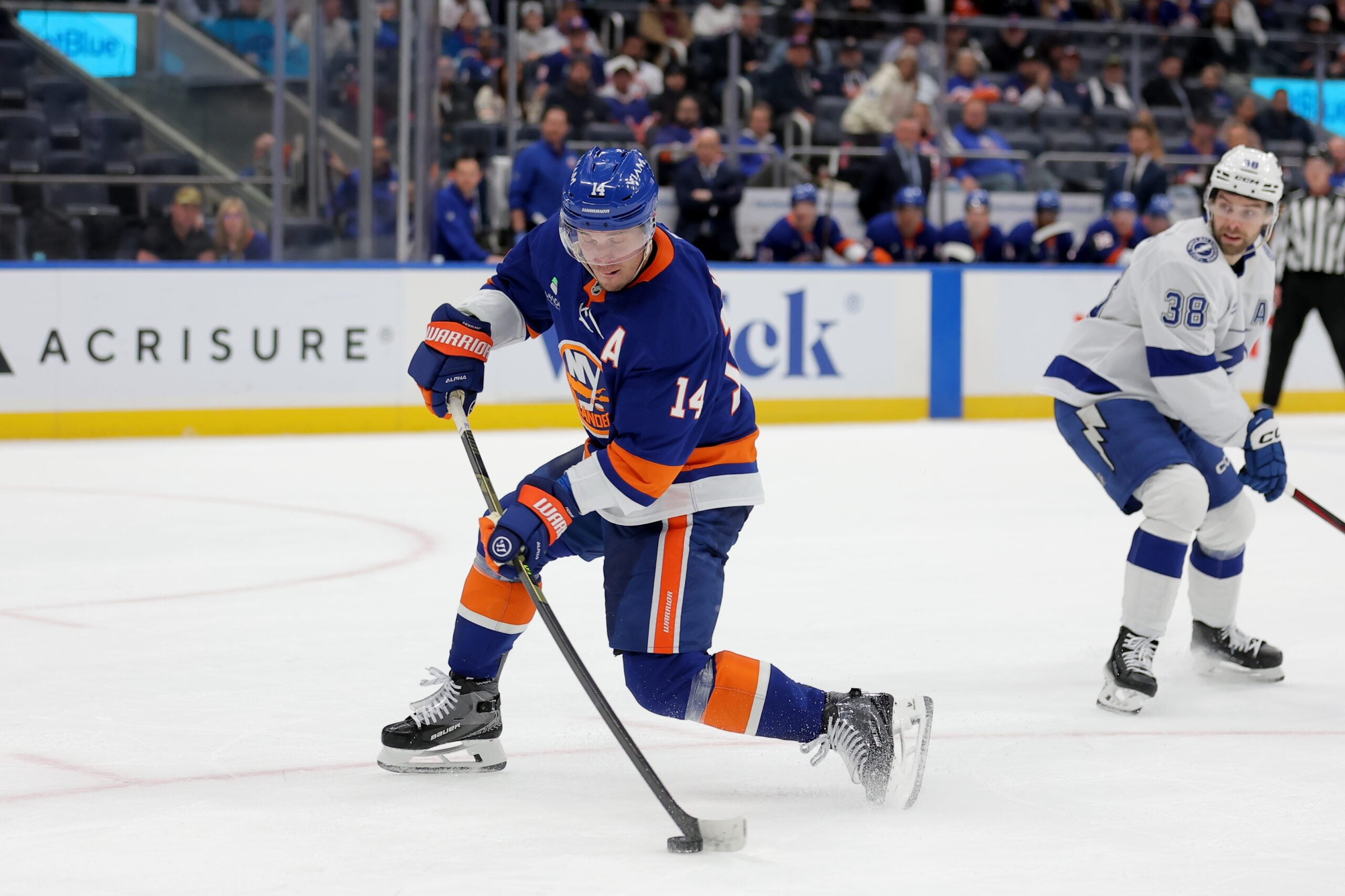 Dec 2, 2025; Elmont, New York, USA; New York Islanders center Bo Horvat (14) takes a shot against Tampa Bay Lightning left wing Brandon Hagel (38) during the second period at UBS Arena. Mandatory Credit: Brad Penner-Imagn Images