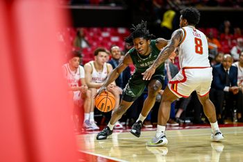 Dec 2, 2025; College Park, Maryland, USA;  Wagner Seahawks guard Michael Cooper (5) dribbles as Maryland Terrapins guard David Coit (8) defends during the first half at Xfinity Center. Mandatory Credit: Tommy Gilligan-Imagn Images