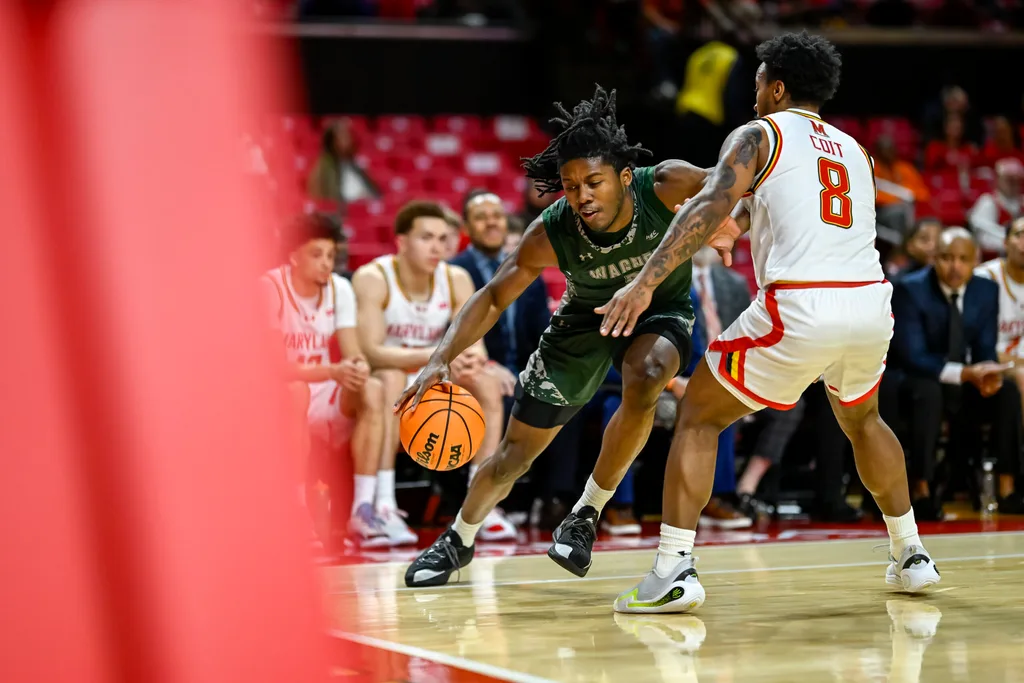 Dec 2, 2025; College Park, Maryland, USA; Wagner Seahawks guard Michael Cooper (5) dribbles as Maryland Terrapins guard David Coit (8) defends during the first half at Xfinity Center. Mandatory Credit: Tommy Gilligan-Imagn Images
