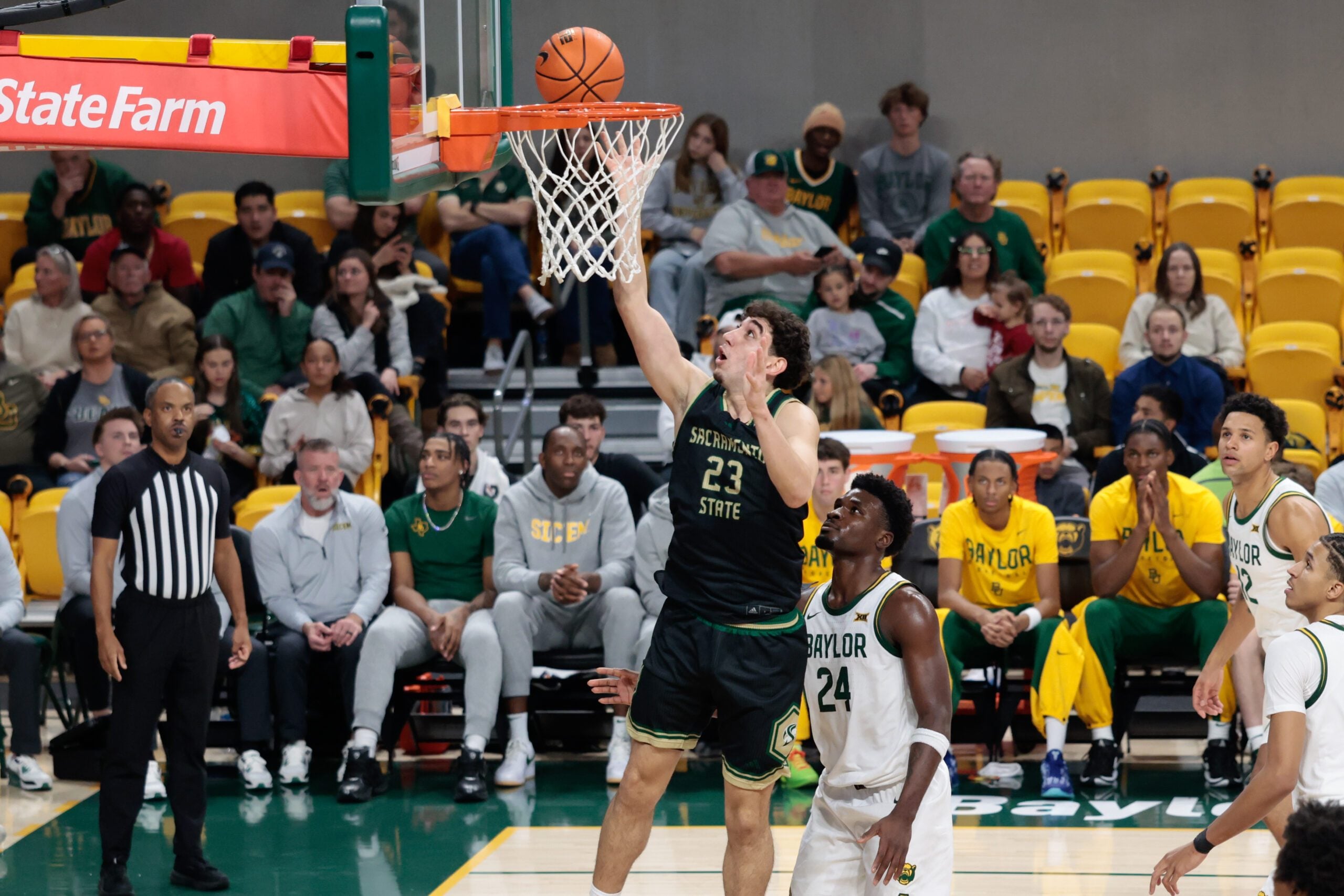 Dec 2, 2025; Waco, Texas, USA; Sacramento State Hornets guard Arman Madi (23) scores a layup past Baylor Bears guard Tounde Yessoufou (24) during the first half at Paul and Alejandra Foster Pavilion. Mandatory Credit: Chris Jones-Imagn Images