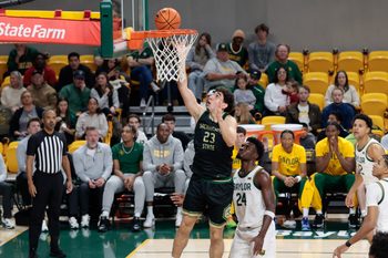 Dec 2, 2025; Waco, Texas, USA; Sacramento State Hornets guard Arman Madi (23) scores a layup past Baylor Bears guard Tounde Yessoufou (24) during the first half at Paul and Alejandra Foster Pavilion. Mandatory Credit: Chris Jones-Imagn Images