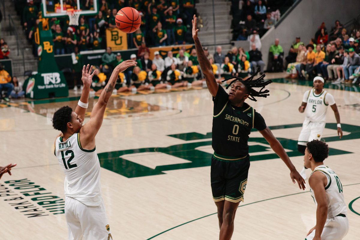 Dec 2, 2025; Waco, Texas, USA; Baylor Bears guard Michael Rataj (12) scores a three-point basket against Sacramento State Hornets forward Brandon Gardner (0) during the second half at Paul and Alejandra Foster Pavilion. Mandatory Credit: Chris Jones-Imagn Images