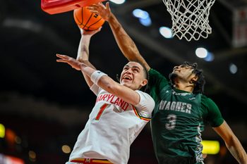 Dec 2, 2025; College Park, Maryland, USA;  Maryland Terrapins guard Darius Adams (1) shoots as Wagner Seahawks guard Elijah Brown (3) defends during the second half at Xfinity Center. Mandatory Credit: Tommy Gilligan-Imagn Images