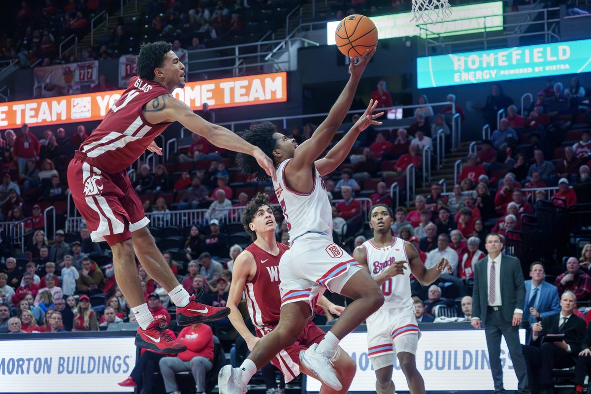 Bradley’s Montana Wheeler gets past Washington State’s Ace Glass for a shot in the second half of their college basketball game Tuesday, Dec. 2, 2025 at Carver Arena in Peoria. The Braves rallied for a 64-60 victory.