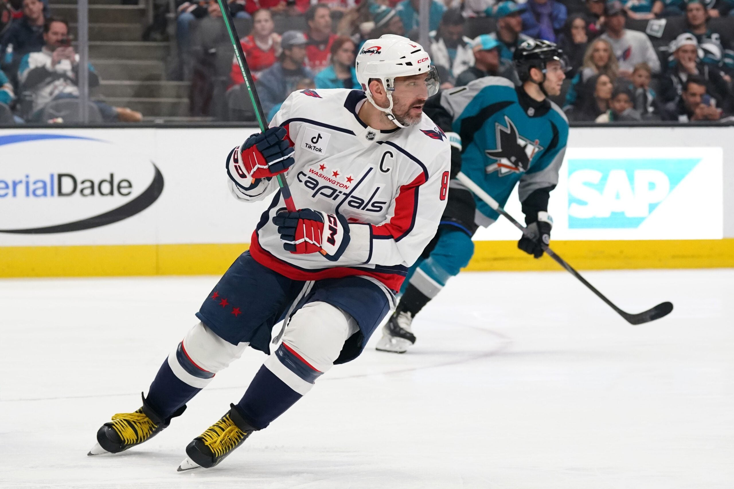 Dec 3, 2025; San Jose, California, USA; Washington Capitals left winger Alex Ovechkin (8) and San Jose Sharks center Alexander Wennberg (21) follow the puck in the third period at SAP Center at San Jose. Mandatory Credit: David Gonzales-Imagn Images