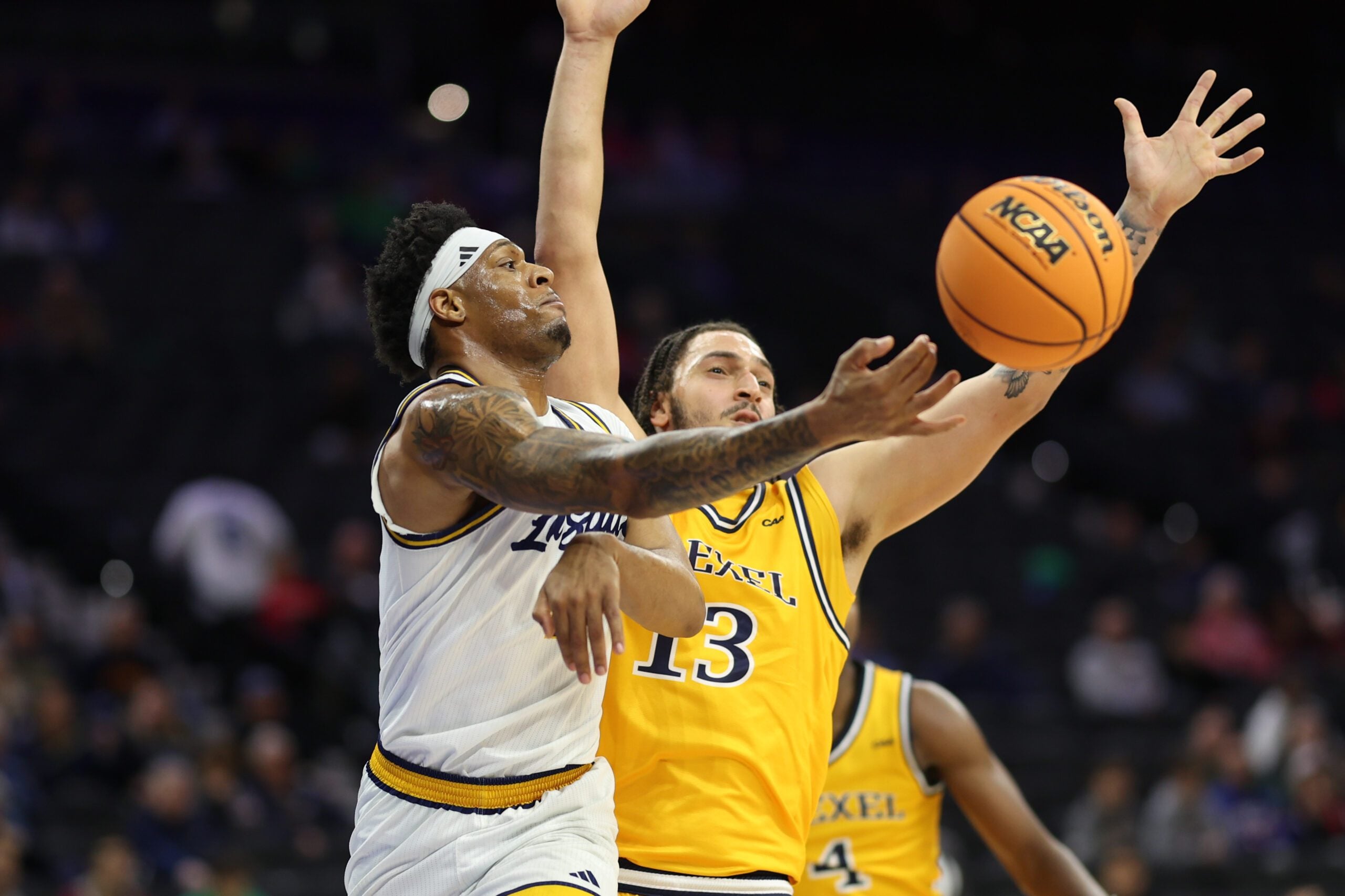Dec 6, 2025; Philadelphia, PA, USA; La Salle Explorers forward Josiah Harris (5) passes the ball past Drexel Dragons forward Garfield Turner (13) during the second half at Xfinity Mobile Arena. Mandatory Credit: Bill Streicher-Imagn Images
