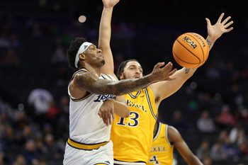 Dec 6, 2025; Philadelphia, PA, USA; La Salle Explorers forward Josiah Harris (5) passes the ball past Drexel Dragons forward Garfield Turner (13) during the second half at Xfinity Mobile Arena. Mandatory Credit: Bill Streicher-Imagn Images