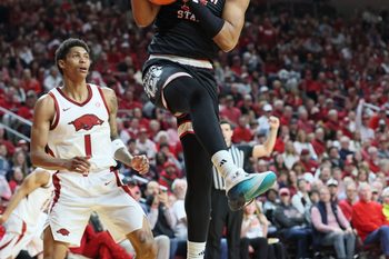 Dec 6, 2025; North Little Rock, Arkansas, USA; Fresno State Bulldogs guard David Douglas Jr (15) rebounds as Arkansas Razorbacks guard Meleek Thomas (1) looks on during the second half at Simmons Bank Arena. Arkansas won 82-58. Mandatory Credit: Nelson Chenault-Imagn Images