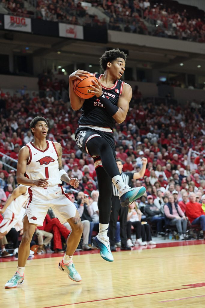 Dec 6, 2025; North Little Rock, Arkansas, USA; Fresno State Bulldogs guard David Douglas Jr (15) rebounds as Arkansas Razorbacks guard Meleek Thomas (1) looks on during the second half at Simmons Bank Arena. Arkansas won 82-58. Mandatory Credit: Nelson Chenault-Imagn Images