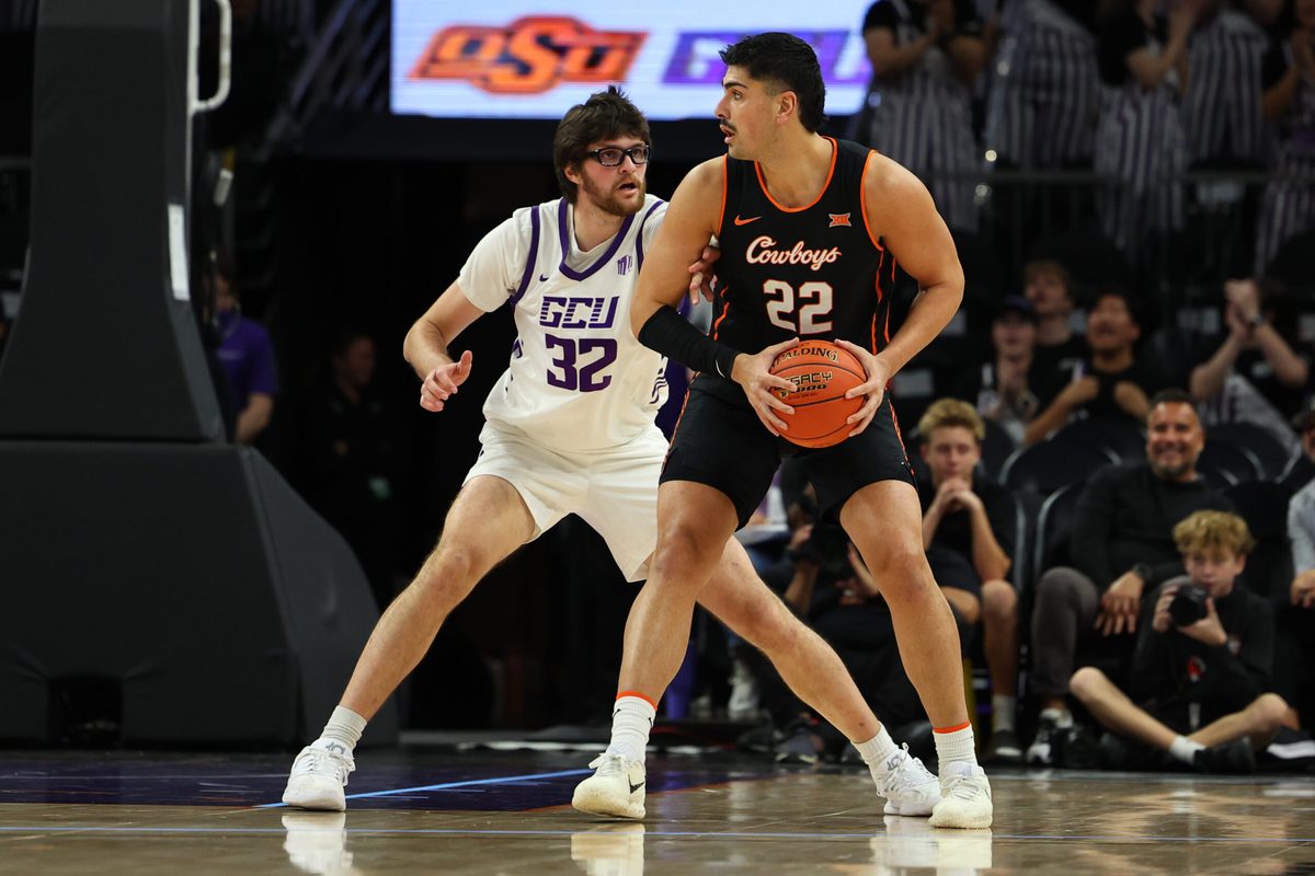 Dec 6, 2025; Phoenix, Arizona, USA; Grand Canyon Lopes forward Wilhelm Breidenbach (32) plays defense on Oklahoma State Cowboys forward Parsa Fallah (22) at PHX Arena. Mandatory Credit: Anna Carrington-Imagn Images
