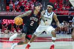 Dec 6, 2025; Salt Lake City, Utah, USA; Utah Utes guard Terrence Brown (2) dribbles the ball against California Baptist Lancers guard Dominique Daniels Jr. (1) during the second half at Jon M. Huntsman Center. Mandatory Credit: Rob Gray-Imagn Images