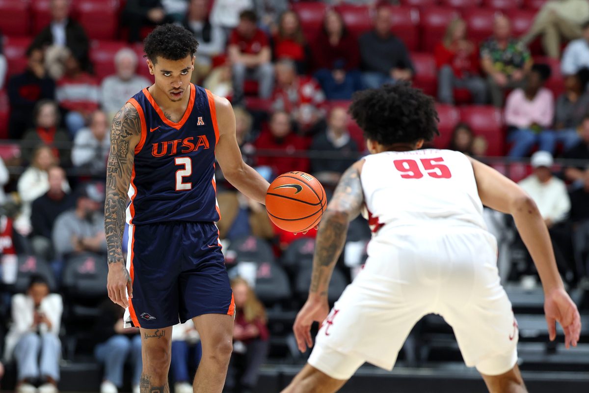 Dec 7, 2025; Tuscaloosa, Alabama, USA; UTSA Roadrunners guard Austin Nunez (2) stares down Alabama Crimson Tide guard Houston Mallette (95) during the first half at Coleman Coliseum. Mandatory Credit: David Leong-Imagn Images