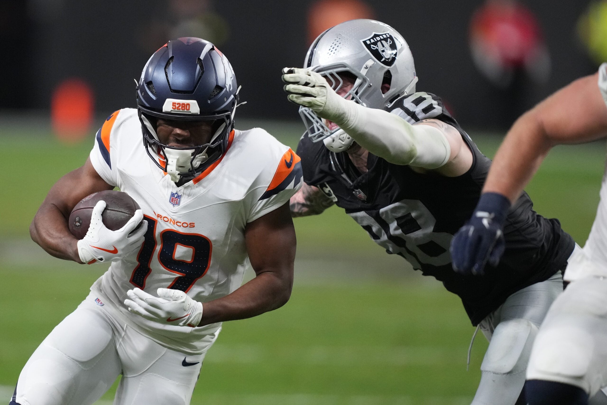 Dec 7, 2025; Paradise, Nevada, USA;  Denver Broncos wide receiver Marvin Mims Jr. (19) is tackled by Las Vegas Raiders defensive end Maxx Crosby (98) during the second half at Allegiant Stadium. Mandatory Credit: Kirby Lee-Imagn Images