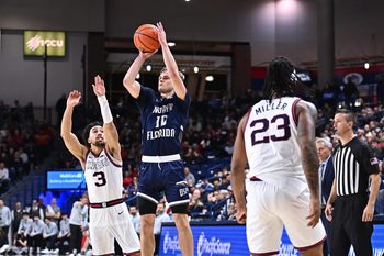 Dec 7, 2025; Spokane, Washington, USA; North Florida Ospreys guard Kent Jackson (10) shoots the ball against Gonzaga Bulldogs guard Braeden Smith (3) in the second half at McCarthey Athletic Center. Mandatory Credit: James Snook-Imagn Images