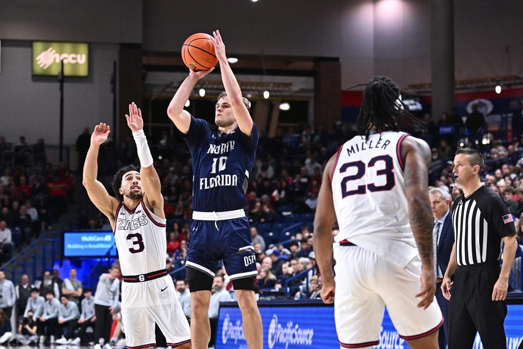 Dec 7, 2025; Spokane, Washington, USA; North Florida Ospreys guard Kent Jackson (10) shoots the ball against Gonzaga Bulldogs guard Braeden Smith (3) in the second half at McCarthey Athletic Center. Mandatory Credit: James Snook-Imagn Images