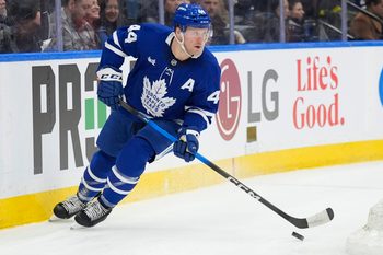 Dec 8, 2025; Toronto, Ontario, CAN; Toronto Maple Leafs defenseman Morgan Rielly (44) carries th epuck against the Tampa Bay Lightning during the second period at Scotiabank Arena. Mandatory Credit: John E. Sokolowski-Imagn Images