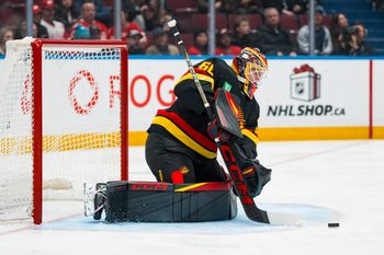 Dec 8, 2025; Vancouver, British Columbia, CAN; Vancouver Canucks goalie Nikita Tolopilo (60) makes a save against the Detroit Red Wings in the third period at Rogers Arena. Mandatory Credit: Bob Frid-Imagn Images