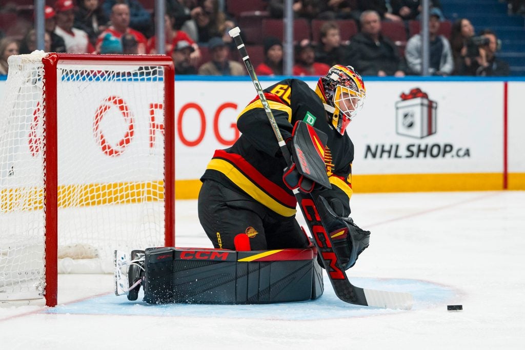 Dec 8, 2025; Vancouver, British Columbia, CAN; Vancouver Canucks goalie Nikita Tolopilo (60) makes a save against the Detroit Red Wings in the third period at Rogers Arena. Mandatory Credit: Bob Frid-Imagn Images