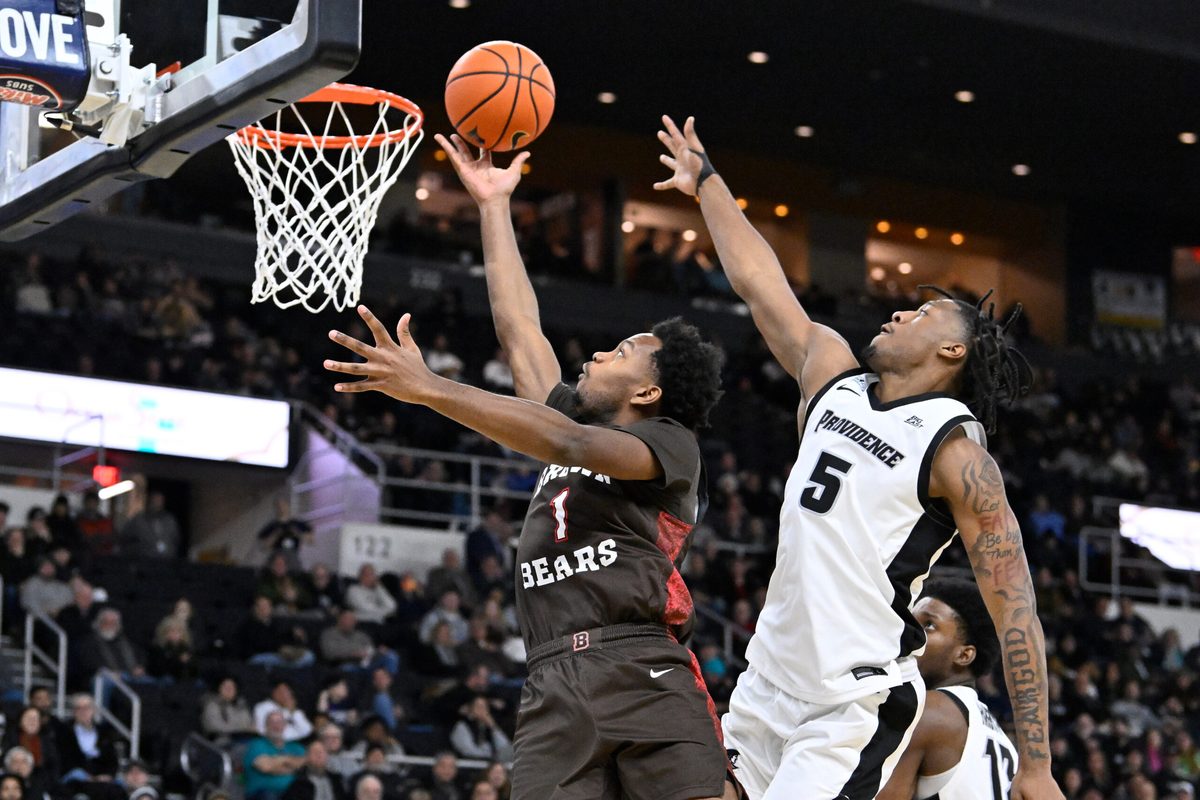 Dec 9, 2025; Providence, Rhode Island, USA; Brown Bears guard Isaiah Langham (1) shoots a layup through the defense of Providence Friars forward Jamier Jones (5) during the second half at Amica Mutual Pavilion. Mandatory Credit: Eric Canha-Imagn Images