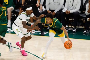 Dec 10, 2025; Waco, Texas, USA;  Norfolk State Spartans guard Anthony McComb III (7) controls the ball as Baylor Bears guard Obi Agbim (5) defends during the first half at Paul and Alejandra Foster Pavilion. Mandatory Credit: Chris Jones-Imagn Images