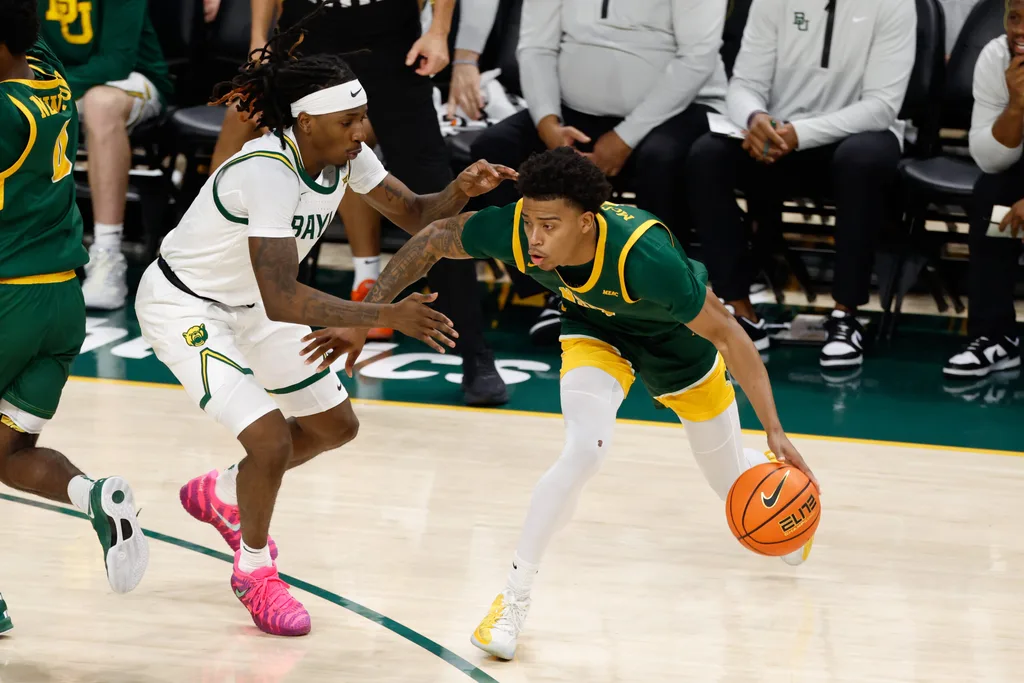 Dec 10, 2025; Waco, Texas, USA; Norfolk State Spartans guard Anthony McComb III (7) controls the ball as Baylor Bears guard Obi Agbim (5) defends during the first half at Paul and Alejandra Foster Pavilion. Mandatory Credit: Chris Jones-Imagn Images