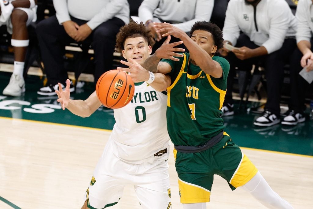Dec 10, 2025; Waco, Texas, USA; Norfolk State Spartans guard Anthony McComb III (7) and Baylor Bears guard Dan Skillings Jr. (0) chase a loose ball during the first half at Paul and Alejandra Foster Pavilion. Mandatory Credit: Chris Jones-Imagn Images