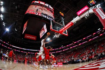 Dec 6, 2025; Raleigh, North Carolina, USA; NC State Wolfpack guard Quadir Copeland (11) dunks the ball past Liberty Flames guard JJ Harper (9) during the first half of the game at Lenovo Center. Mandatory Credit: Jaylynn Nash-Imagn Images