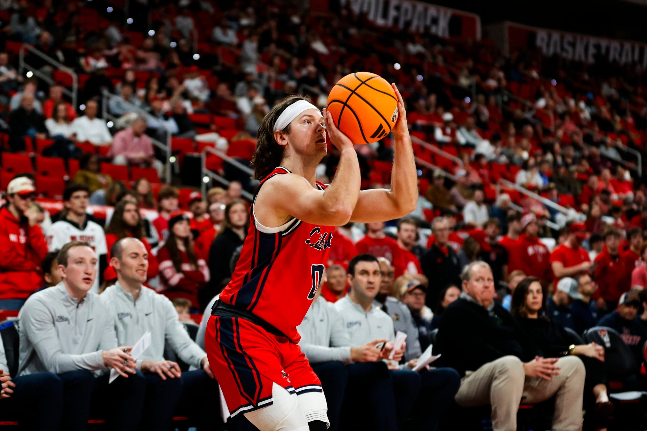 Dec 6, 2025; Raleigh, North Carolina, USA; Liberty Flames guard Colin Porter (0) shoots a three point shot during the second half of the game against the NC State Wolfpack at Lenovo Center. Mandatory Credit: Jaylynn Nash-Imagn Images