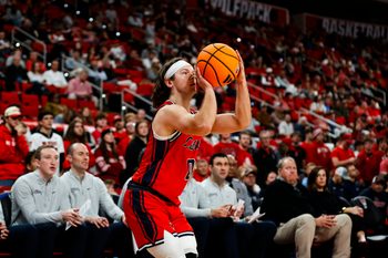 Dec 6, 2025; Raleigh, North Carolina, USA; Liberty Flames guard Colin Porter (0) shoots a three point shot during the second half of the game against the NC State Wolfpack at Lenovo Center. Mandatory Credit: Jaylynn Nash-Imagn Images
