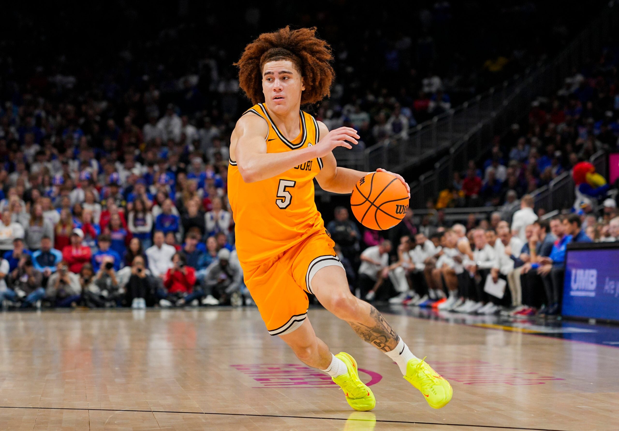 Dec 7, 2025; Kansas City, Missouri, USA; Missouri Tigers guard T.O. Barrett (5) dribbles the ball during the second half against the Kansas Jayhawks at T-Mobile Center. Mandatory Credit: Jay Biggerstaff-Imagn Images