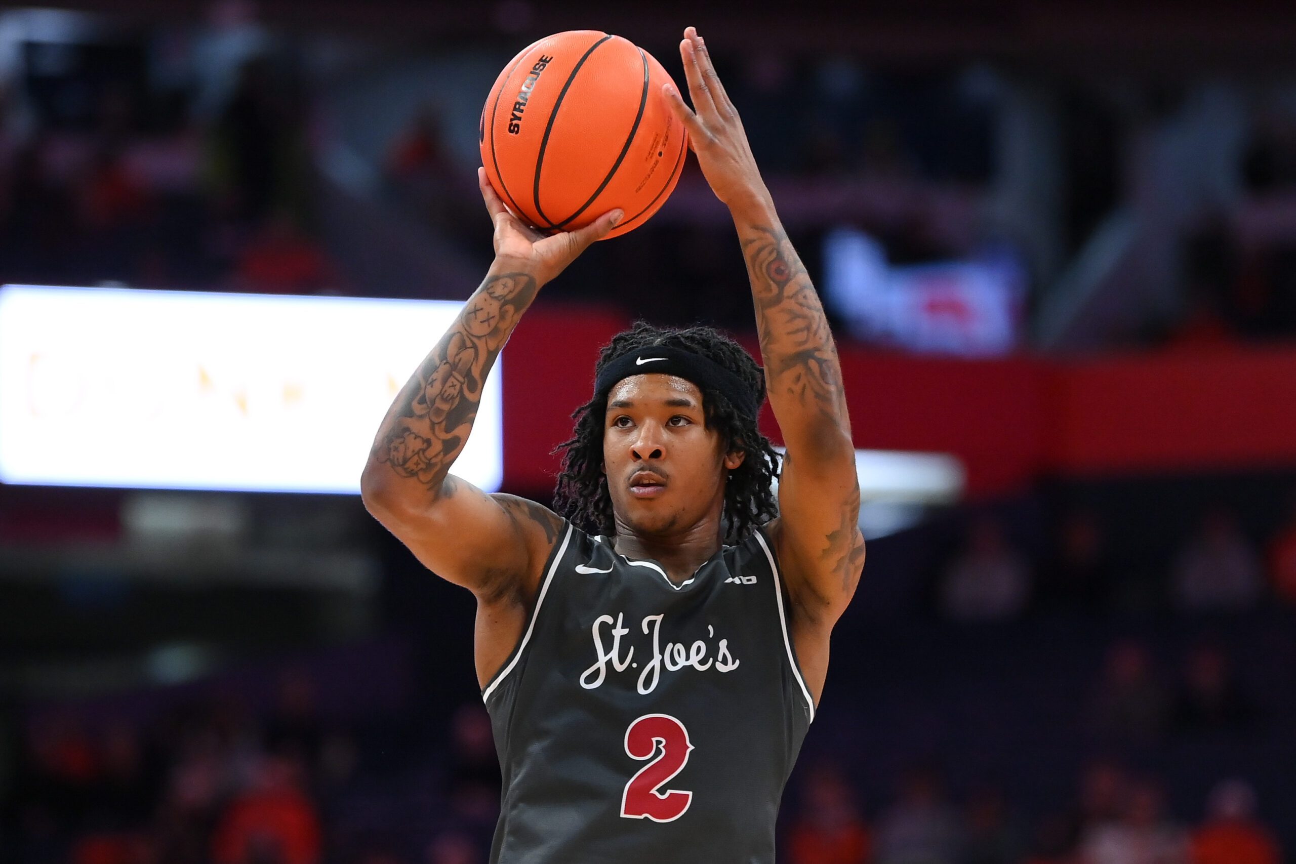Dec 11, 2025; Syracuse, New York, USA; Saint Joseph's Hawks guard Deuce Jones (2) shoots against the Syracuse Orange during the first half at the JMA Wireless Dome. Mandatory Credit: Rich Barnes-Imagn Images