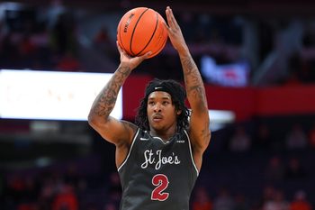 Dec 11, 2025; Syracuse, New York, USA; Saint Joseph's Hawks guard Deuce Jones (2) shoots against the Syracuse Orange during the first half at the JMA Wireless Dome. Mandatory Credit: Rich Barnes-Imagn Images