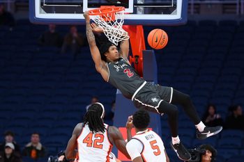 Dec 11, 2025; Syracuse, New York, USA; Saint Joseph's Hawks guard Deuce Jones (2) attempts a dunk as Syracuse Orange forward William Kyle III (42) and forward Tyler Betsey (5) defend during the second half at the JMA Wireless Dome. Mandatory Credit: Rich Barnes-Imagn Images