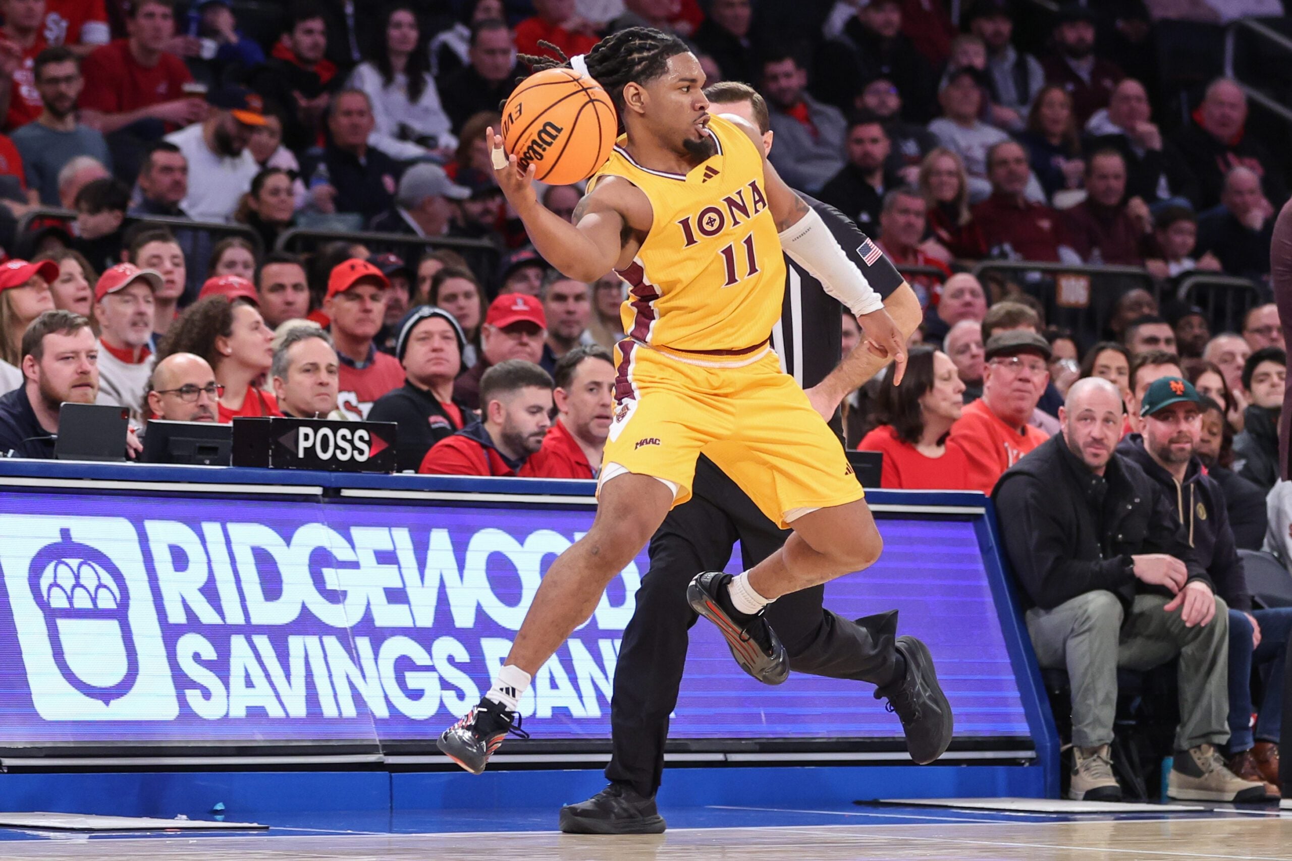 Dec 13, 2025; Queens, New York, USA; Iona Gaels guard C.J. Anthony (11) leaps trying to avoid a backcourt violation in the second half against the St. John's Red Storm at Madison Square Garden. Mandatory Credit: Wendell Cruz-Imagn Images