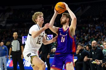 Dec 13, 2025; South Bend, Indiana, USA; Evansville Purple Aces forward Joshua Hughes (11) works against Notre Dame Fighting Irish forward Garrett Sundra (12) during the second half at Purcell Pavilion at the Joyce Center. Mandatory Credit: Michael Caterina-Imagn Images