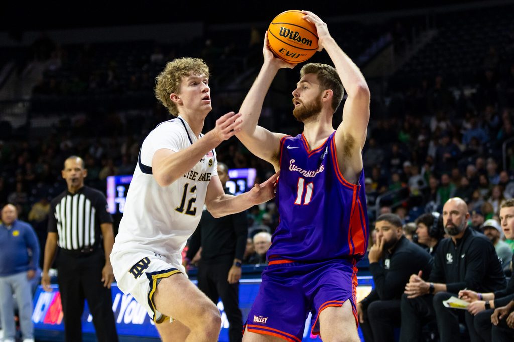 Dec 13, 2025; South Bend, Indiana, USA; Evansville Purple Aces forward Joshua Hughes (11) works against Notre Dame Fighting Irish forward Garrett Sundra (12) during the second half at Purcell Pavilion at the Joyce Center. Mandatory Credit: Michael Caterina-Imagn Images