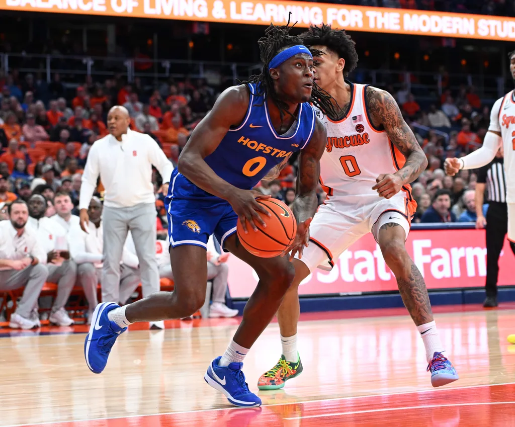 Dec 13, 2025; Syracuse, New York, USA; Hofstra Pride guard Biggie Patterson (0) drives in the first half against the Syracuse Orange at the JMA Wireless Dome. Mandatory Credit: Mark Konezny-Imagn Images