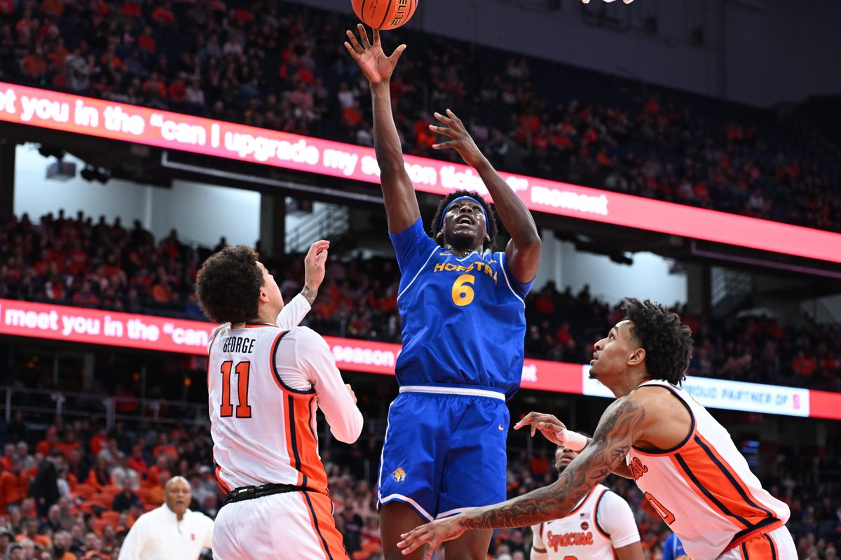 Dec 13, 2025; Syracuse, New York, USA; Hofstra Pride forward Victory Onuetu (6) shoots against Syracuse Orange guard Naithan George (11) and forward Sadiq White Jr. (0) defend in the first half at the JMA Wireless Dome. Mandatory Credit: Mark Konezny-Imagn Images