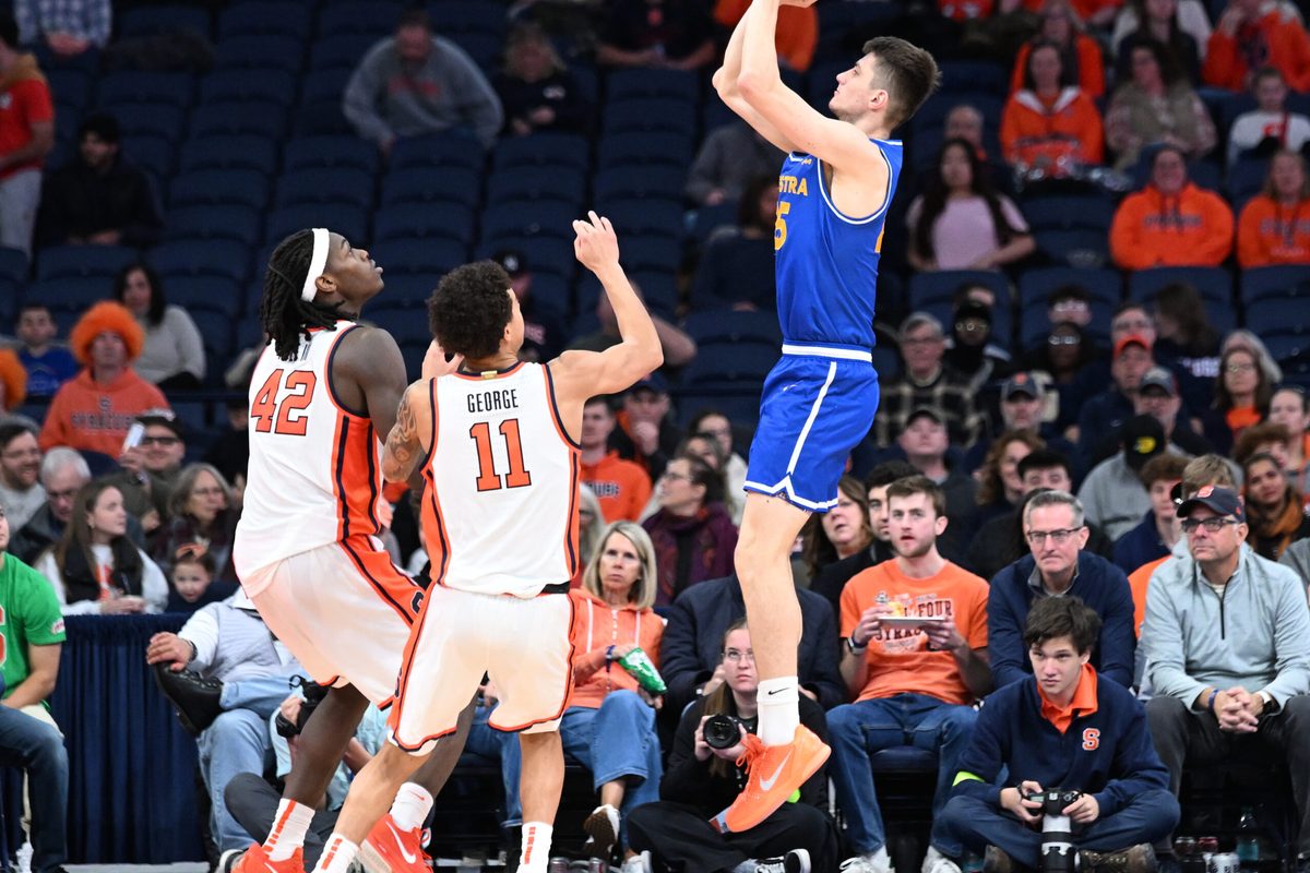 Dec 13, 2025; Syracuse, New York, USA; Hofstra Pride guard German Plotnikov (25) shoots against Syracuse Orange forward William Kyle III (42) and guard Naithan George (11) in the second half at the JMA Wireless Dome. Mandatory Credit: Mark Konezny-Imagn Images