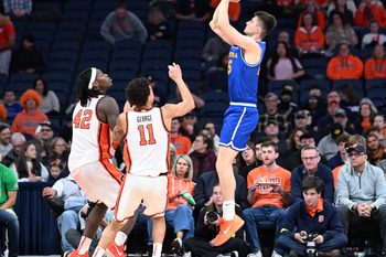 Dec 13, 2025; Syracuse, New York, USA; Hofstra Pride guard German Plotnikov (25) shoots against Syracuse Orange forward William Kyle III (42) and guard Naithan George (11) in the second half at the JMA Wireless Dome. Mandatory Credit: Mark Konezny-Imagn Images