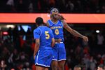 Dec 13, 2025; Syracuse, New York, USA; Hofstra Pride guard Biggie Patterson (0) and guard Cruz Davis (5) react to winning a game against the Syracuse Orange at the JMA Wireless Dome. Mandatory Credit: Mark Konezny-Imagn Images