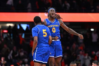 Dec 13, 2025; Syracuse, New York, USA; Hofstra Pride guard Biggie Patterson (0) and guard Cruz Davis (5) react to winning a game against the Syracuse Orange at the JMA Wireless Dome. Mandatory Credit: Mark Konezny-Imagn Images
