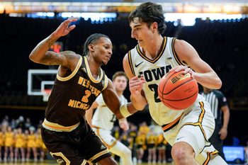 Iowa guard Tate Sage (24) drives toward the basket against Western Michigan guard Jalen Griffith (2) Dec. 14, 2025 at Carver-Hawkeye Arena in Iowa City, Iowa.