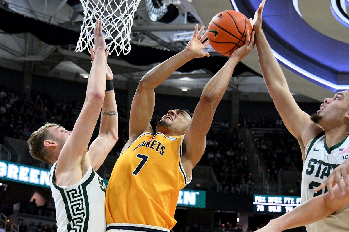 Dec 16, 2025; East Lansing, Michigan, USA;  Toledo Rockets forward Sean Craig (7) gets blocked by Michigan State Spartans forward Jesse McCulloch (35) during the first half at Jack Breslin Student Events Center. Mandatory Credit: Dale Young-Imagn Images