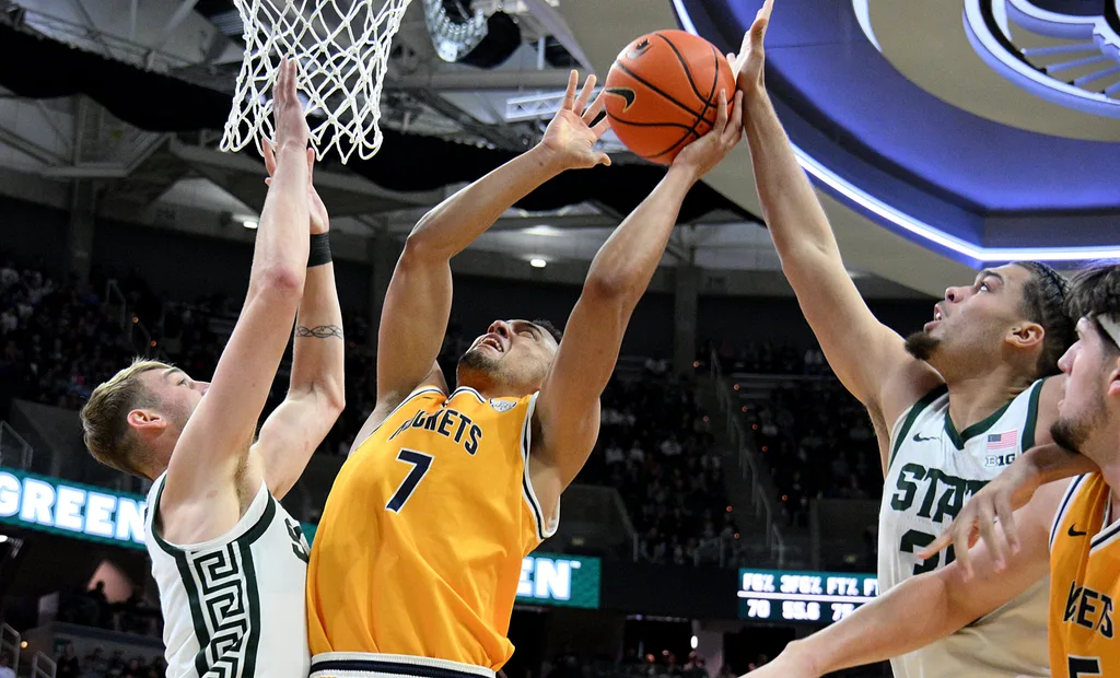 Dec 16, 2025; East Lansing, Michigan, USA; Toledo Rockets forward Sean Craig (7) gets blocked by Michigan State Spartans forward Jesse McCulloch (35) during the first half at Jack Breslin Student Events Center. Mandatory Credit: Dale Young-Imagn Images