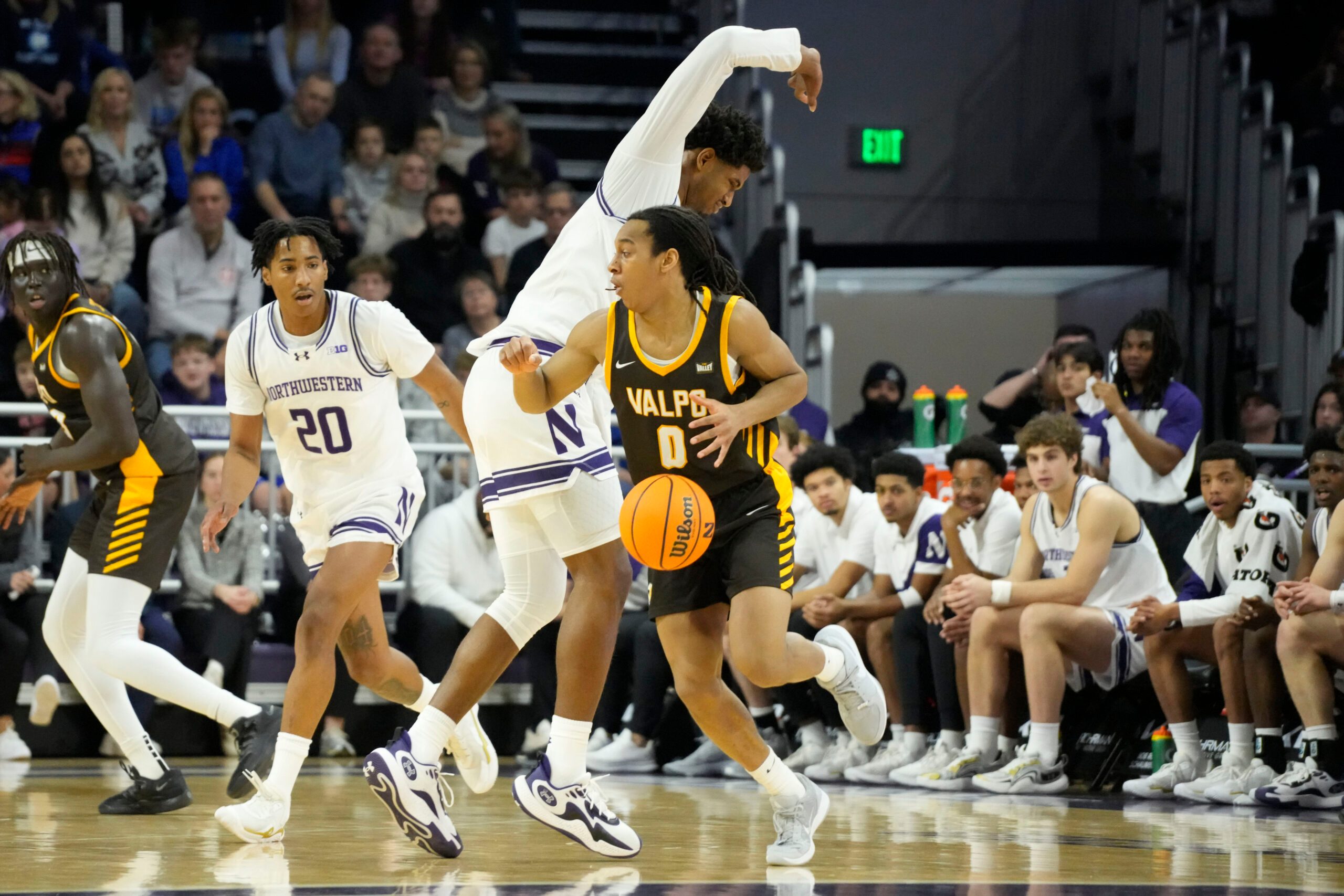 Dec 16, 2025; Evanston, Illinois, USA; Northwestern Wildcats forward Arrinten Page (22) defends Valparaiso Beacons guard Rakim Chaney (0) during the first half at Welsh-Ryan Arena. Mandatory Credit: David Banks-Imagn Images